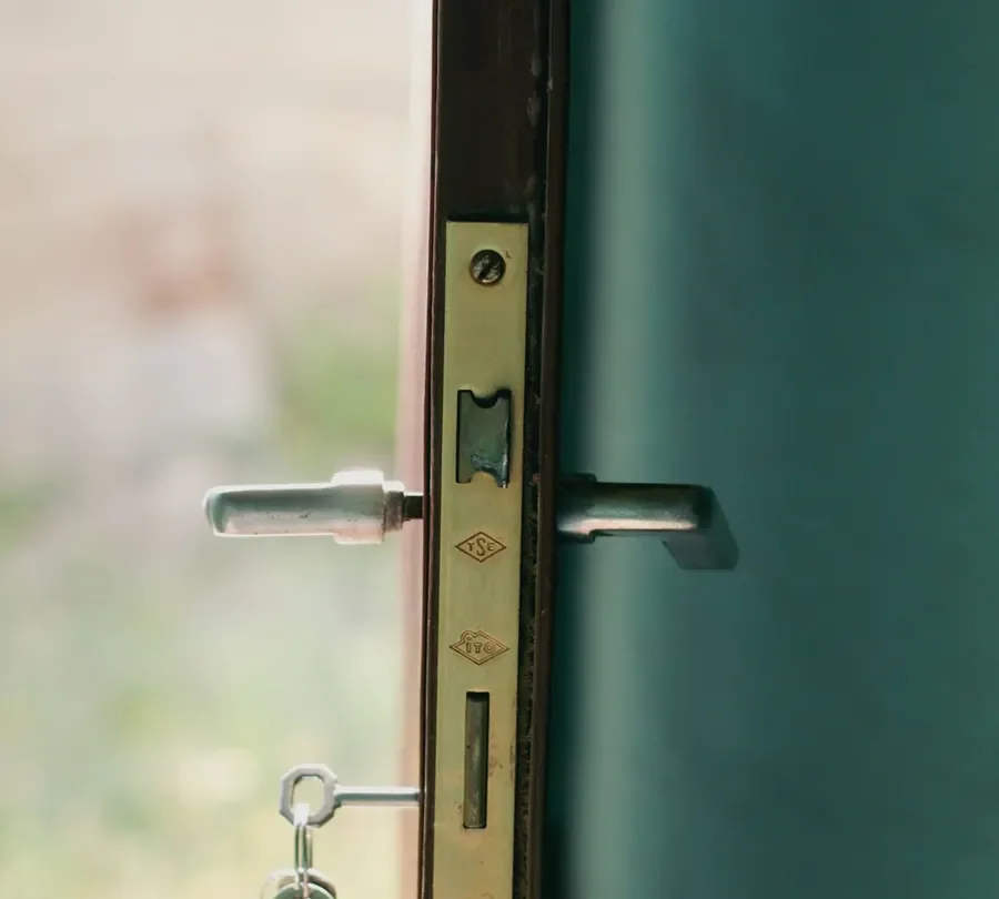 Door edge with a lock faceplate, lever handles and key – checking the multipoint mechanism before you change a uPVC door lock in Bournemouth, Locksmith Bournemouth guide