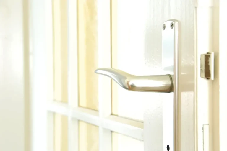 How to change a uPVC door lock in Bournemouth – white door with a lever handle on a long backplate, Locksmith Bournemouth guide to barrel, handle and multipoint replacement